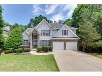 Charming two-story home with well-manicured lawn and a two-car garage at 420 Gold Xing, Canton, GA 30114