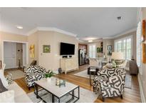 Bright living room featuring stylish furnishings, hardwood floors and an open floor plan to kitchen at 1055 Piedmont Ne Ave # 401, Atlanta, GA 30309
