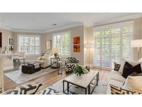 Bright living room features hardwood floors, shutters on the windows and a neutral color palette at 1055 Piedmont Ne Ave # 401, Atlanta, GA 30309