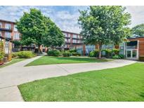 A beautiful condo building with well-manicured landscaping and lush green lawn at 5200 Peachtree Rd # 1104, Atlanta, GA 30341