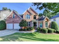 Beautiful two-story brick home with a well-manicured lawn and a two-car garage at 1301 Dayspring Trce, Lawrenceville, GA 30045