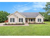 Charming single-story home with manicured lawn, tasteful landscaping, and classic curb appeal at 215 Nina Circle Cir, Locust Grove, GA 30248