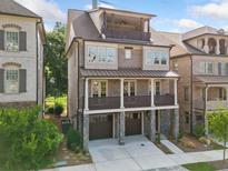 Stunning three-story home with a brick exterior, balconies, and a two-car garage at 2111 Bellrick Nw Rd, Atlanta, GA 30318