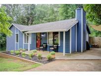 Charming blue house with covered porch and well-manicured landscaping at 3076 Montheath Pass, Duluth, GA 30096
