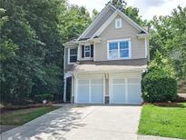 Charming home with a two-car garage and a well-manicured lawn at 1346 Upshur Pl, Buford, GA 30519