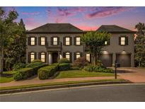 Beautiful home featuring a manicured lawn and a symmetrical facade with a charming balcony and attached two-car garage at 3015 Southmoor Trce, Roswell, GA 30075
