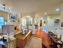 Spacious living room with hardwood floors, fireplace, and large windows that bring in a lot of natural light at 1349 Orchard Park Dr, Stone Mountain, GA 30083