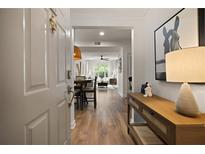 Inviting hallway with wood floors, console table, and view into the living and dining areas at 123 Ashford Cir, Atlanta, GA 30338