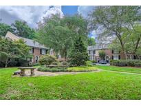 Charming townhomes surround a lush green courtyard with manicured landscaping and mature trees at 1634 Ponce De Leon Ne Ave # 512, Atlanta, GA 30307