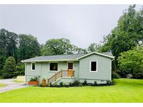 Charming cottage-style home featuring a freshly painted exterior and manicured lawn at 1042 Oakdale Se Dr, Smyrna, GA 30080