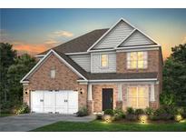 Charming two-story brick home with white trim, landscaped yard, and a two-car garage at 5110 Mulberry Pass Ct, Hoschton, GA 30548