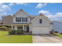 Charming two-story home with a manicured front yard and attached two-car garage, creating a welcoming curb appeal at 27 Autumn Canyon Se Path, Cartersville, GA 30121