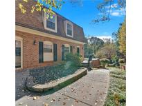 Charming two-story home features a brick facade, manicured landscaping, and inviting entrance at 1261 Lavista Ne Rd # E-8, Atlanta, GA 30324