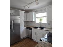 Bright kitchen features stainless steel appliances, white cabinets, and granite countertops at 48 Peachtree Ne Ave # 321, Atlanta, GA 30305
