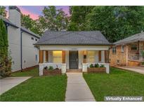 Charming single-story home with a welcoming front porch, planter boxes, and a well-manicured lawn at 995 Lena Nw St, Atlanta, GA 30314