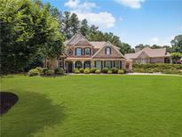 Beautiful brick home featuring a well-manicured lawn, tasteful landscaping and a welcoming entrance at 3315 High Noontide Nw Way, Acworth, GA 30101