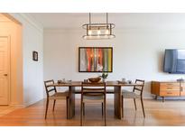 Bright dining area with hardwood floors, stylish lighting fixture, and seating for four at 400 17Th St # 2325, Atlanta, GA 30363