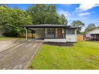 Charming renovated home with a covered carport and inviting front porch at 1553 Mccallie Nw Blvd, Atlanta, GA 30318