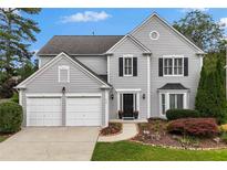 Charming two-story home features a well-manicured lawn, two-car garage, and inviting front entrance at 520 Weatherend Ct, Johns Creek, GA 30022