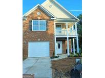 Two-story brick house with a front-facing garage and porch at 6398 Shadow Sq, Lithonia, GA 30058