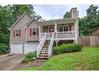 Charming home with two-car garage, covered front porch, and beautiful landscaping at 80 Broadlands Dr, White, GA 30184