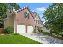 Beautiful brick two-story home featuring an attached two-car garage and a well-maintained front lawn at 3059 Brookgreen Trl, Lawrenceville, GA 30043