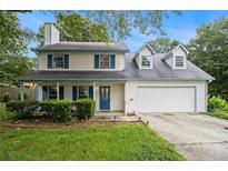 Charming two-story home featuring blue shutters, a well-maintained lawn and two car garage at 4214 Fiddlers Bnd, Loganville, GA 30052