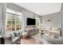 Bright living room featuring hardwood floors, large windows, and elegant furnishings at 1055 Piedmont Ne Ave # 106, Atlanta, GA 30309