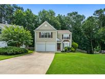 Charming two-story home with a well-manicured lawn and a two-car garage at 496 Bottesford Nw Dr, Kennesaw, GA 30144