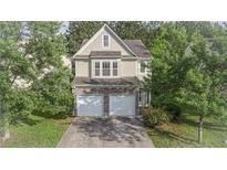 Charming two-story home featuring a stone-accented facade, two-car garage, and lush landscaping at 4350 Annlette Dr, Lawrenceville, GA 30044