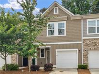 Charming townhome with attached garage, neat landscaping, and neutral colored siding in an attractive neighborhood at 3135 Journal Ct, Decatur, GA 30035