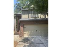 Two-story townhome with attached garage and brick and siding facade, including concrete driveway at 1278 Houndslake Dr, Marietta, GA 30008