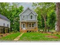 Two-story home with light grey siding, white trim, and a covered porch at 38 Mildred Nw Pl, Atlanta, GA 30318