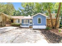 Charming home featuring blue siding, white trim, and a well-manicured front yard at 937 Ohara Drive Dr, Jonesboro, GA 30236