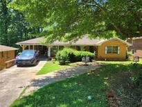 Charming home with a spacious front yard, screened-in porch, and brick exterior at 965 Stokeswood Se Ave, Atlanta, GA 30316