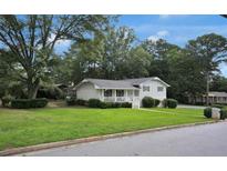 Charming home with a well-manicured lawn and inviting front porch, perfect for relaxing outdoors at 3835 Clearwater Dr, Atlanta, GA 30349