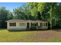 Charming single-story home with black shutters, surrounded by mature trees and a well-maintained lawn at 2802 3Rd Sw Ave, Atlanta, GA 30315