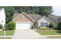 Charming one-story home with stone accents, a two-car garage, and a well-manicured lawn at 414 Norton Xing, Woodstock, GA 30188