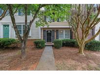 Charming townhome featuring well-maintained landscaping, inviting entryway, and classic architectural details at 1066 Wedgewood Ln, Tucker, GA 30084