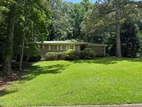 Charming single-story home featuring a brick facade and lush green landscaping at 2990 Piedmont Dr, Marietta, GA 30066