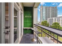 Condo balcony featuring an outdoor bar area with city view, and views through the sliding doors to the unit at 390 17Th Nw St # 6055, Atlanta, GA 30363