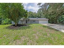 Charming single-story home with a well-maintained lawn, classic gray siding, and a two-car garage at 3181 Woodbridge Ct, Snellville, GA 30039