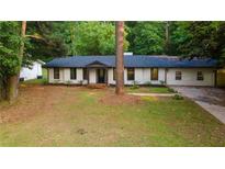 Charming renovated ranch-style home featuring a dark roof, black trim windows, and freshly painted brick at 3790 Village Sw Dr, Atlanta, GA 30331