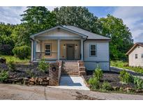 Charming craftsman home featuring a welcoming front porch and landscaped front yard at 5445 Eva Mamie Ln, Stone Mountain, GA 30083