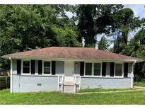 Charming single-story home with a well-manicured lawn and lush landscaping at 2245 Polar Rock Sw Ave, Atlanta, GA 30315