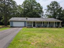 Charming single-story home with a covered front porch and attached garage at 446 Westbrook Rd, Carrollton, GA 30116