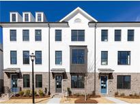 Charming townhome exterior featuring a painted brick facade and contrasting window trim at 629 Silva St # 128, Cumming, GA 30040