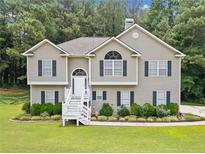 Charming two-story home with a well-manicured lawn and inviting front porch at 6355 Autumn View Nw Pt, Acworth, GA 30101