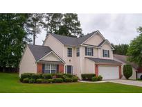 Charming two-story home with well-manicured lawn and brick accents, perfect for suburban living at 1332 Chandler Cove Way, Grayson, GA 30017