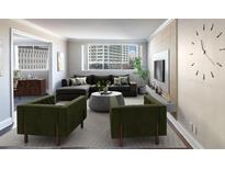 Inviting living room featuring modern decor, a comfortable sectional, and large windows with city views at 215 Piedmont Ne Ave # 502, Atlanta, GA 30308